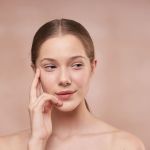woman holding her face
