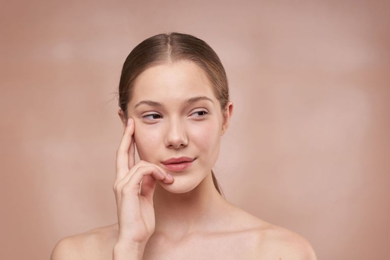 woman holding her face